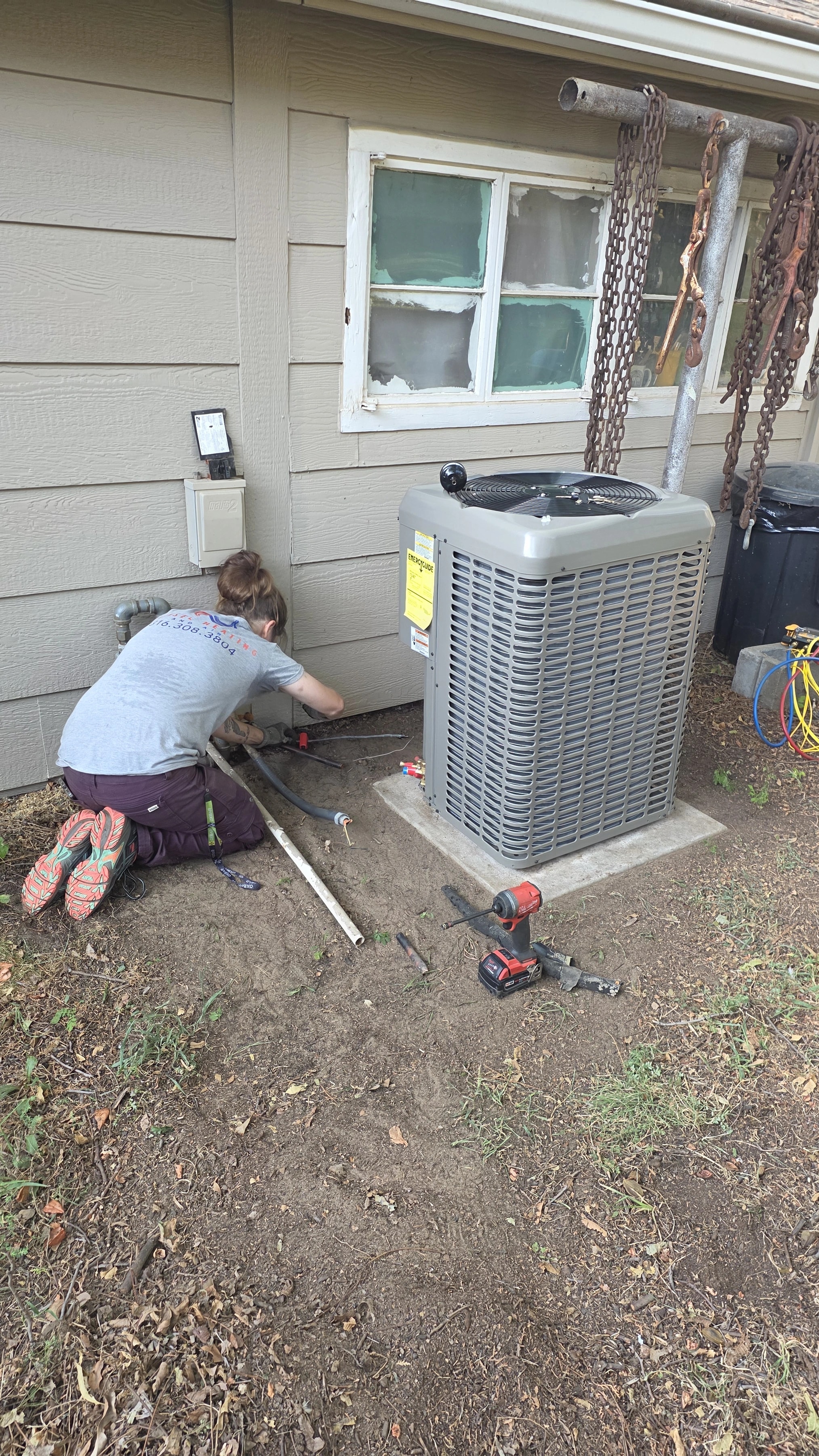 A younger family member beside AC equipment